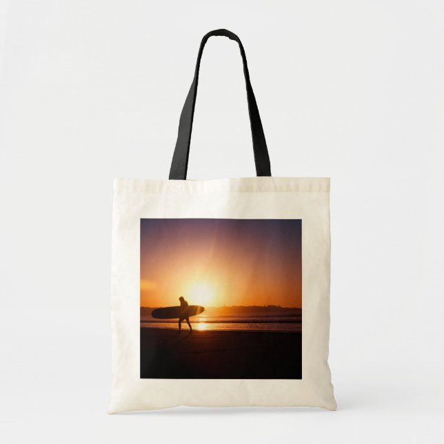 Surfer with Surfboard on Beach at Sunset Tote Bag (Front)