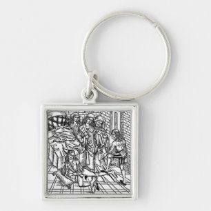 Surgeon directs as an assistant breaks and resets keychain