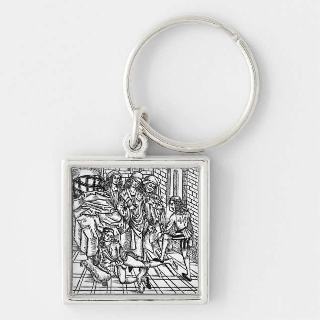 Surgeon directs as an assistant breaks and resets keychain (Front)