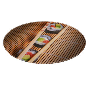 Sushi and wooden chopsticks cutting board