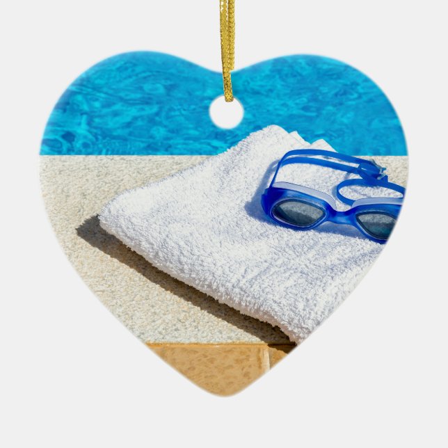 Swimming goggles and towel near swimming pool ceramic ornament (Front)
