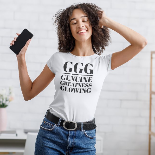 T-shirt GGG- Véritable, Grandeur, Glissant (Young woman dances in "GGG: Genuine, Greatness, Glowing" white t-shirt.)