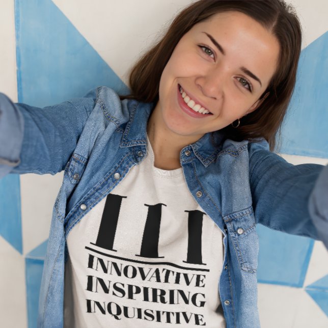 T-shirt III- Innovateur, Inspirant, Inquisiteur (Young woman wears a "III: Innovative, Inspiring, Inquisitive" white t-shirt.)