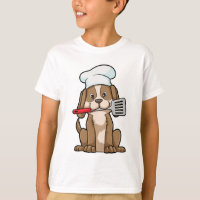 Le chien cuisinier avec le casquette et la spatule