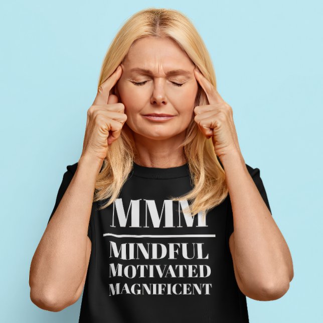 T-shirt MMM- Minutieux, Motivé, Magnifique (Middle aged Caucasian woman wears a t-shirt that reads "MMM: Mindful, Motivated, Magnificent")