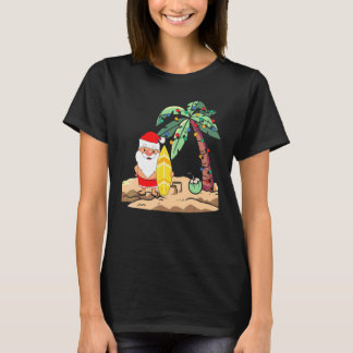 T-shirt Noël en juillet Santa tenant un surfeur sur une pl