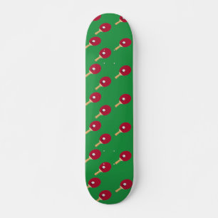 Table tennis racket and ball on green skateboard