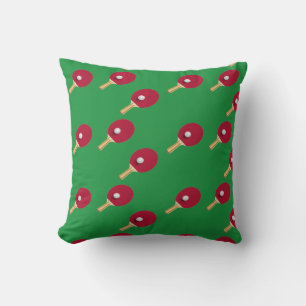 Table tennis racket and ball on green throw pillow