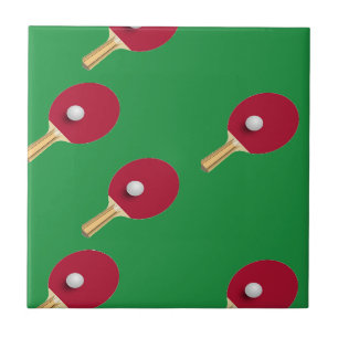 Table tennis racket and ball on green tile