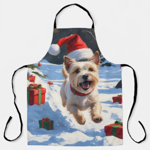 Tablier Terrier Cairn courant dans la neige avec un chapea