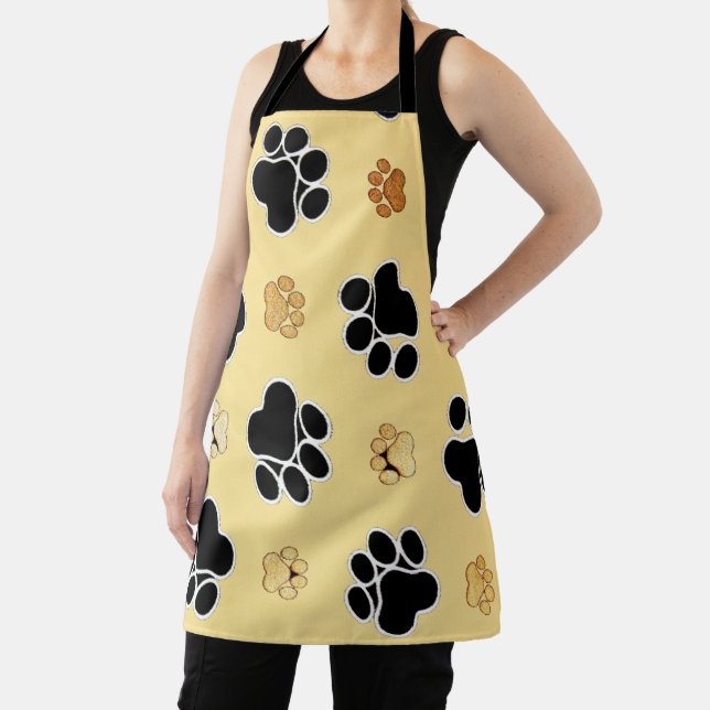 Tan and black paw print on a gold background  apron (Insitu)