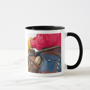 Tasse Cow-boy sur un cheval portant des chaps en cuir