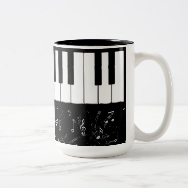 Tasse noire et blanche de musique de piano (Droit)