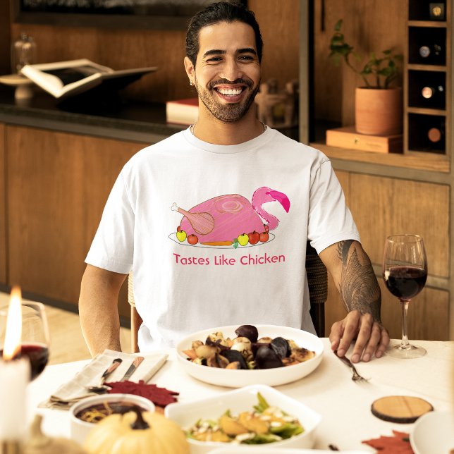 Tastes Like Chicken Funny Flamingo T-Shirt (male model at a holiday dinner wearing pink flamingo tastes like chicken funny t-shirt)