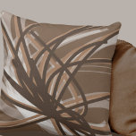 Taupe and Brown Neutral Abstract Ribbons Throw Pillow<br><div class="desc">Taupe and brown throw pillow features an artistic neutral abstract ribbon composition with shades of taupe and brown with white accents on a neutral taupe background. The warm neutral hues of taupe blend beautifully with dark brown to create a neutral modern pattern that's sure to compliment any room in your...</div>