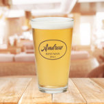 Taupe Stylized Wedding Best Man Name Glass<br><div class="desc">Beer glass for the wedding Best Man that features his name printed in a trendy taupe colour, stylized script inside a taupe colour oval border along with wedding date. A great party supply idea for a bachelor party! Personalize your beer glass by editing and replacing name and date with your...</div>