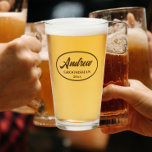 Taupe Stylized Wedding Groomsman Glass<br><div class="desc">Beer glass for the wedding groomsman that features his name printed in a taupe colour, stylized script inside a taupe colour oval border along with wedding date. A great party supply idea for a bachelor party! Personalize your beer glass by editing and replacing name and date with your own. Available...</div>