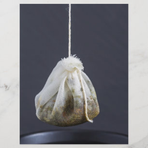 Tea bag is hung in a cup