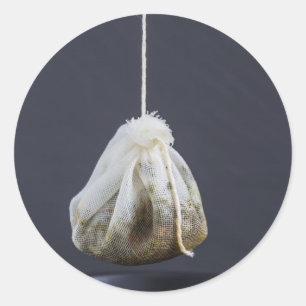 Tea bag is hung in a cup classic round sticker
