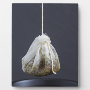 Tea bag is hung in a cup plaque