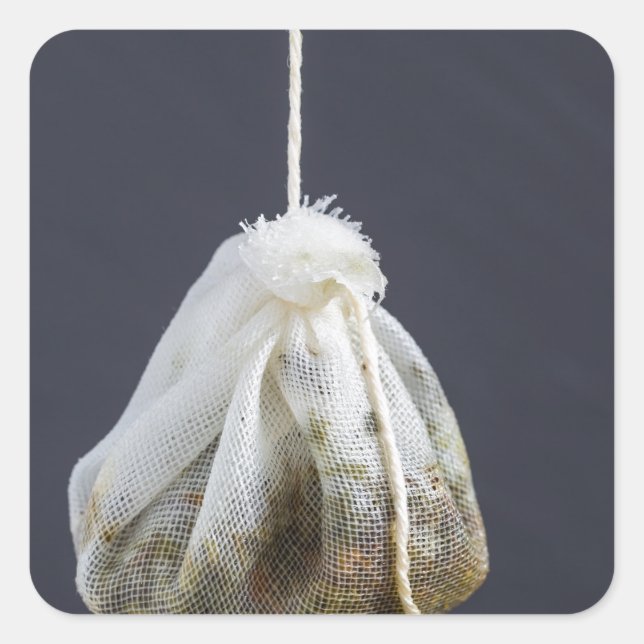 Tea bag is hung in a cup square sticker (Front)