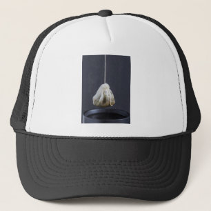 Tea bag is hung in a cup trucker hat