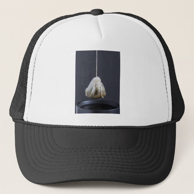 Tea bag is hung in a cup trucker hat (Front)