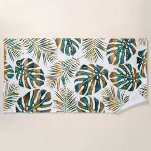 Teal and gold patterned tropical leaves beach towel