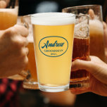Teal Blue Stylized Wedding Groomsman Glass<br><div class="desc">Beer glass for the wedding groomsman that features his name printed in a trendy, teal blue colour, stylized script inside a teal blue colour oval border along with wedding year date. A great party supply idea for a bachelor party! Personalize your beer glass by editing and replacing name and date...</div>