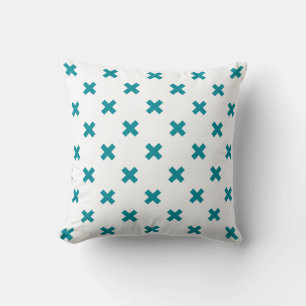 Teal cross stitches on white throw pillow