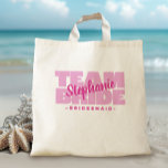 Team Bride Bridal Party Name Bridesmaid Pink Retro Tote Bag<br><div class="desc">Custom tote bag design for your bridal party features "TEAM BRIDE" in bold light pink type. Customize bridesmaid name in coordinating dark bright pink script. Title or custom text is featured below. All colours in this design are customizable in the Zazzle design tool area! Design repeats on the back. Message...</div>