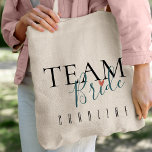 Team Bride | Bridesmaid | Wedding Tote Bag<br><div class="desc">Team Bride | Bridesmaid | Wedding Tote Bag .Personalized bridesmaid tote bags are a thoughtful and practical way to show your appreciation for your bridesmaids. They're also a great way to add a personal touch to your wedding day. Zazzle offers a wide variety of personalized bridesmaid tote bags to choose...</div>