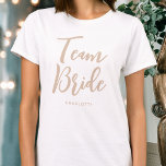 Team Bride Wedding Personalized Beige White T-Shirt<br><div class="desc">Celebrate your bride squad with this personalized wedding t-shirt! The words 'Team Bride' are written in a trendy script font, and below you can add a custom name, wedding date, location or other text. A lovely gift for a bachelorette party, wedding shower or celebration weekend! Colours: natural beige and white....</div>