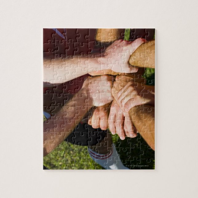 Team with arms-in jigsaw puzzle (Vertical)
