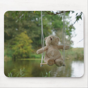 Teddy bear on a swing on a tree mouse pad