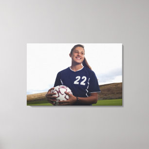 teen girl soccer player holding soccer ball canvas print