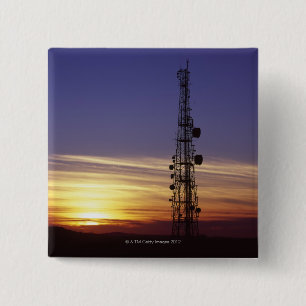Telecommunications mast at sunset 2 inch square button