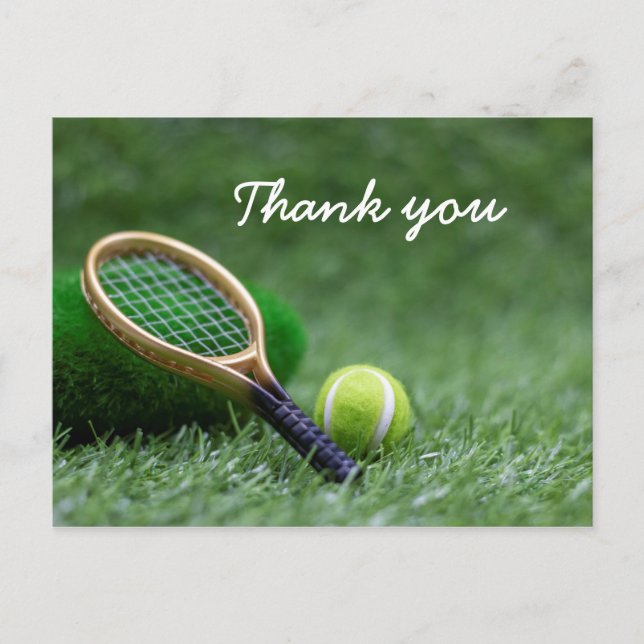 Tennis ball and racket on green grass postcard (Front)