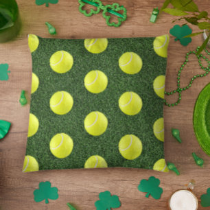Tennis ball on green grass throw pillow