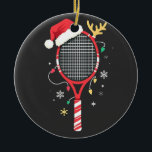 Tennis Paddle with Santa Hat and Christmas Lights Ceramic Ornament<br><div class="desc">Christmas tennis,  holiday sports,  tennis paddle Santa hat,  festive tennis,  Christmas lights,  holiday spirit,  tennis player gift,  sports Christmas,  holiday tennis fan,  Christmas sports cheer</div>