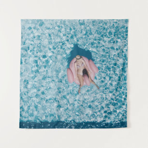 Tenture Woman on pink buoy surrounded by body of water in
