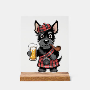 Terrier écossais en kilt tartan avec bière et pipe