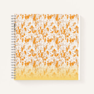 Textile pattern featuring a vibrant orange and gol notebook