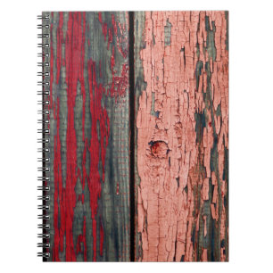 Texture of old wooden fence painted in red and ora notebook