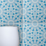 Textured Blue White Stylized Symmetrical Floral Tile<br><div class="desc">The design of this ceramic tile design is dominated by stylized floral motifs, arranged harmoniously across the tile. The colour palette is a soothing spectrum of varying shades of blue, creating a striking contrast and depth that draws the eye. The background texture adds an additional layer of visual interest, enhancing...</div>