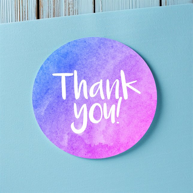 Thank you watercolour bright sticker (Round thank-you sticker with a blue and purple watercolor gradient and handwritten-style white text.)