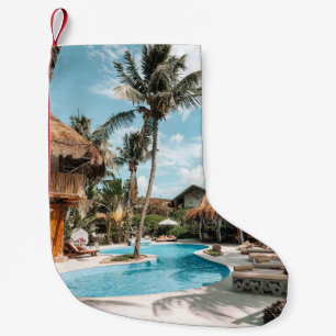 Thatch huts and houses by the pool during day small christmas stocking