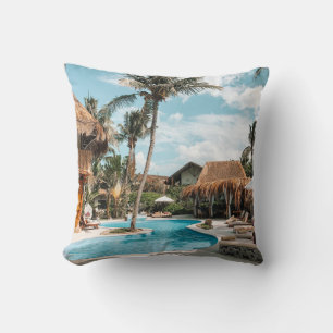 Thatch huts and houses by the pool during day throw pillow