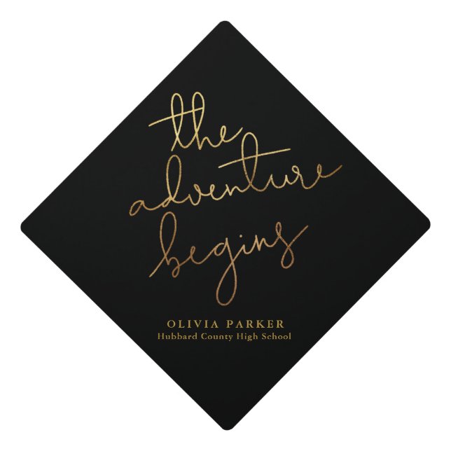 the adventure begins gold black typography graduation cap topper (Front)