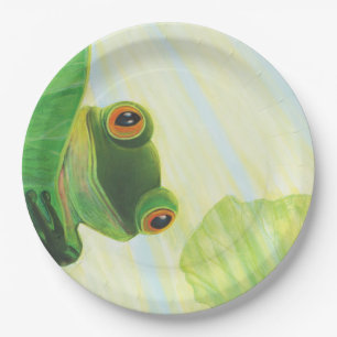 The big-eyed green frog behind lily pad   paper plate